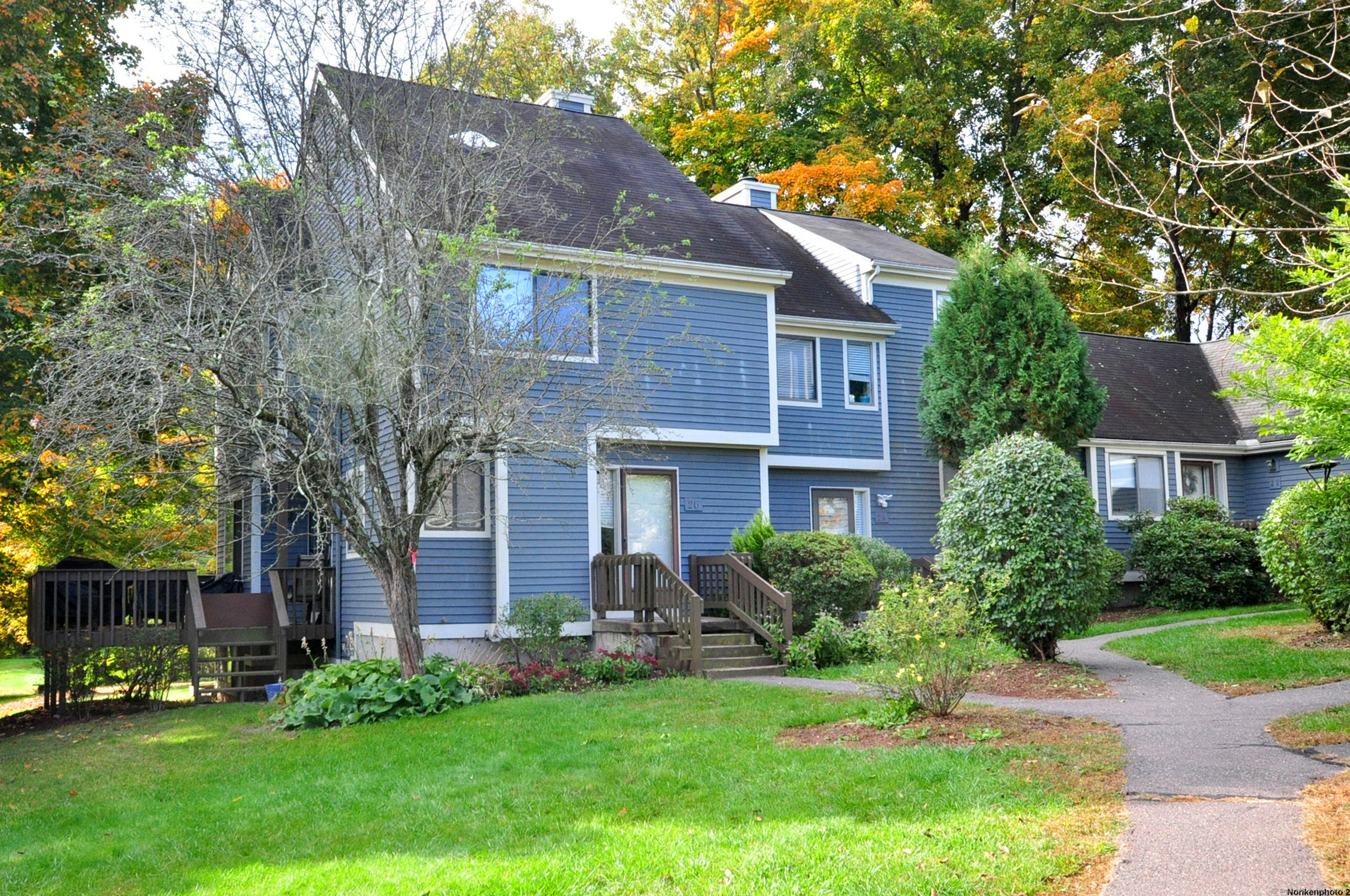 a front view of house with yard and green space