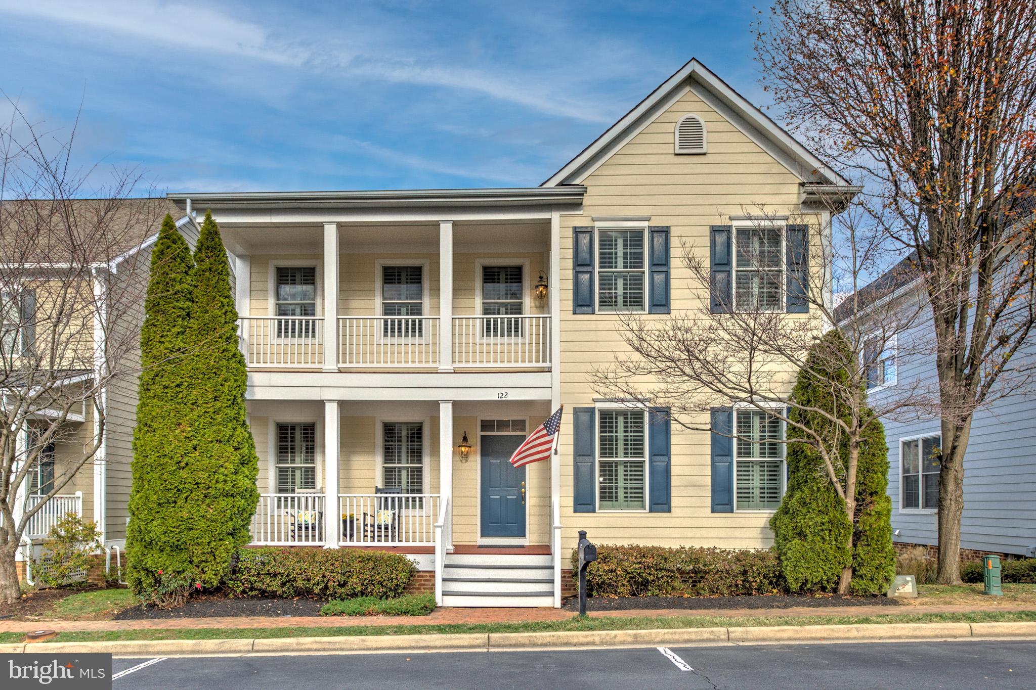 front view of a brick house with a yard