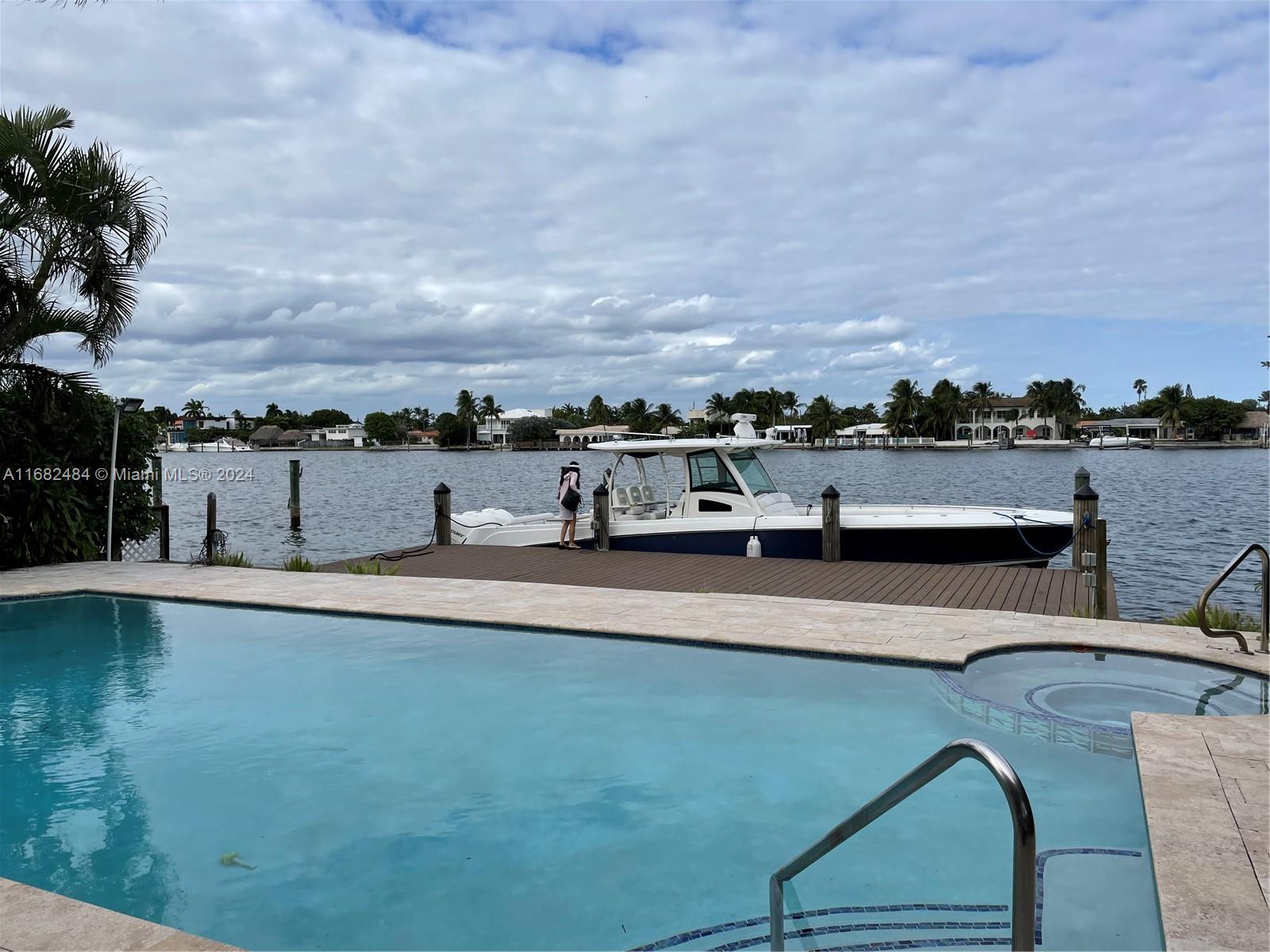 a view of a swimming pool with an outdoor seating