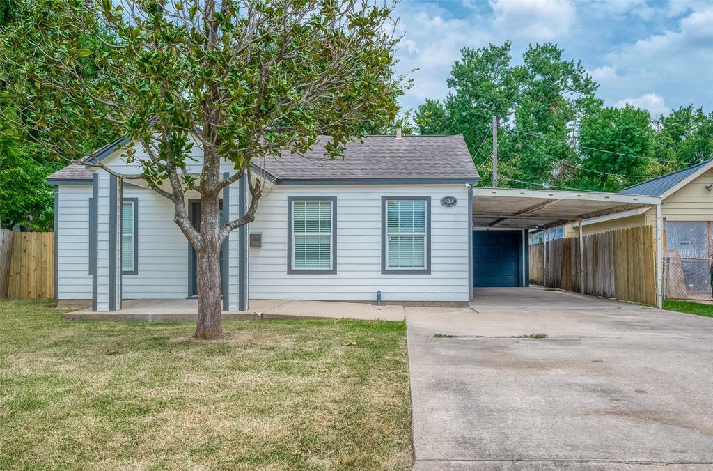 a house that has a tree in front of a house