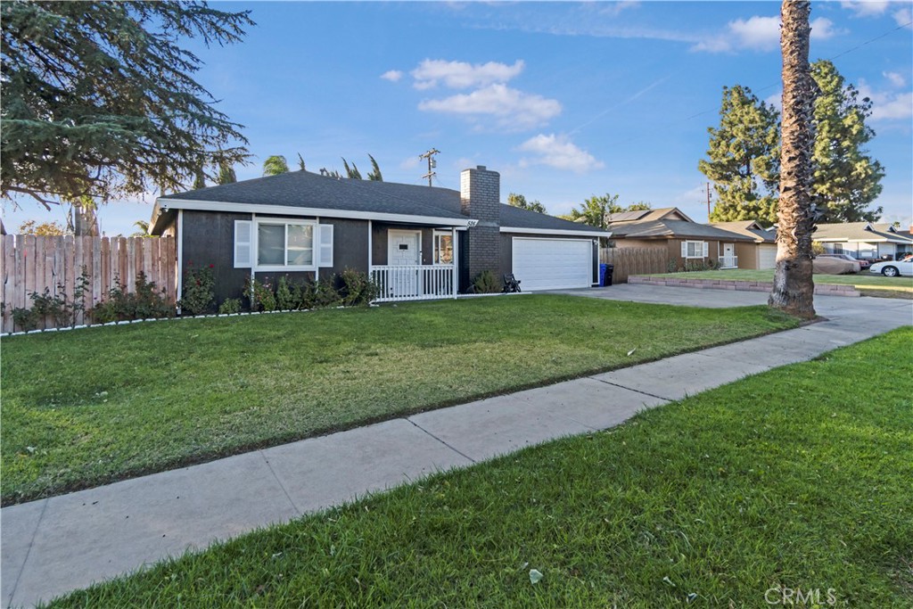 a front view of a house with a garden and yard