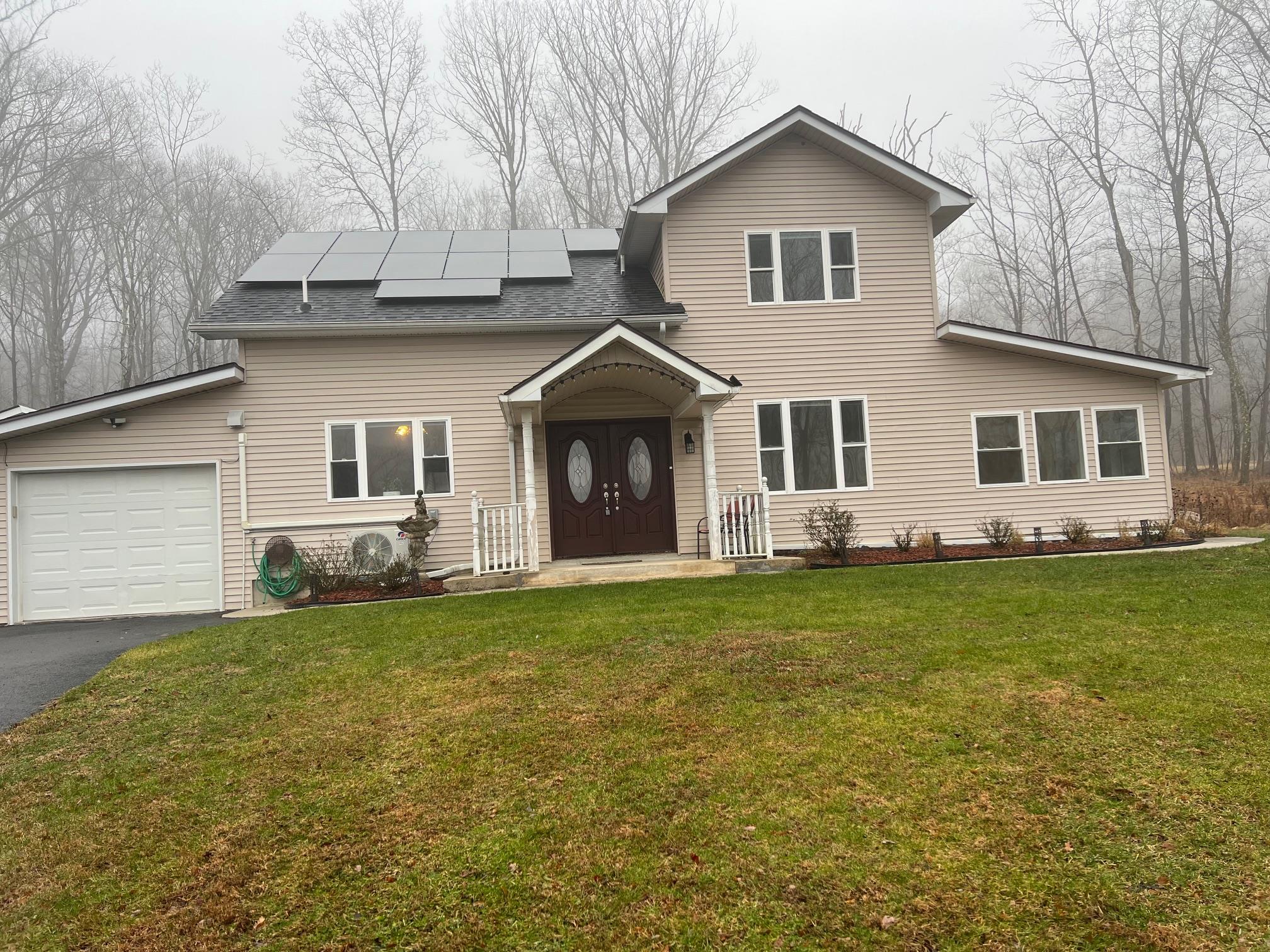 a front view of a house with a garden