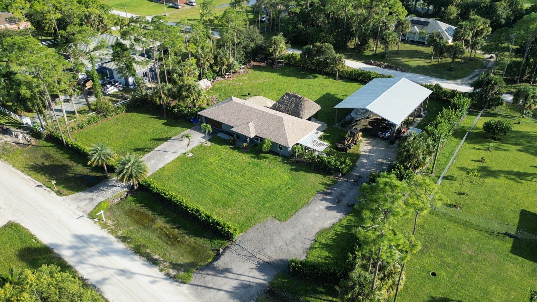 an aerial view of a house with yard swimming pool and outdoor seating