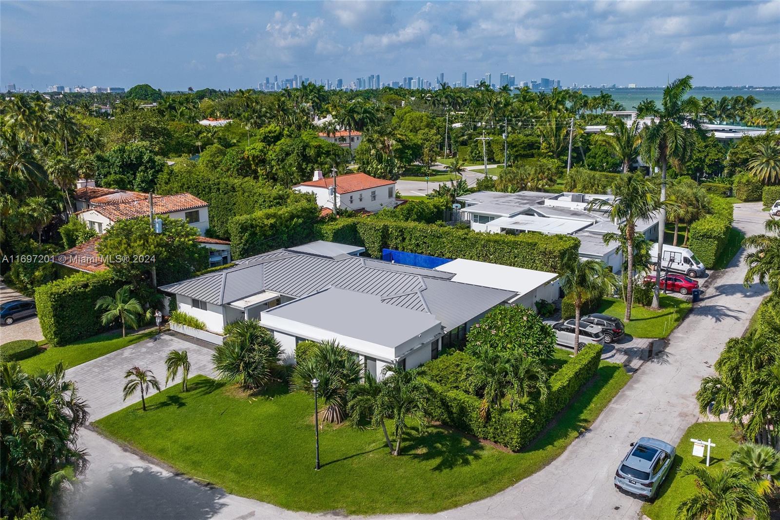 an aerial view of a house with garden space and street view