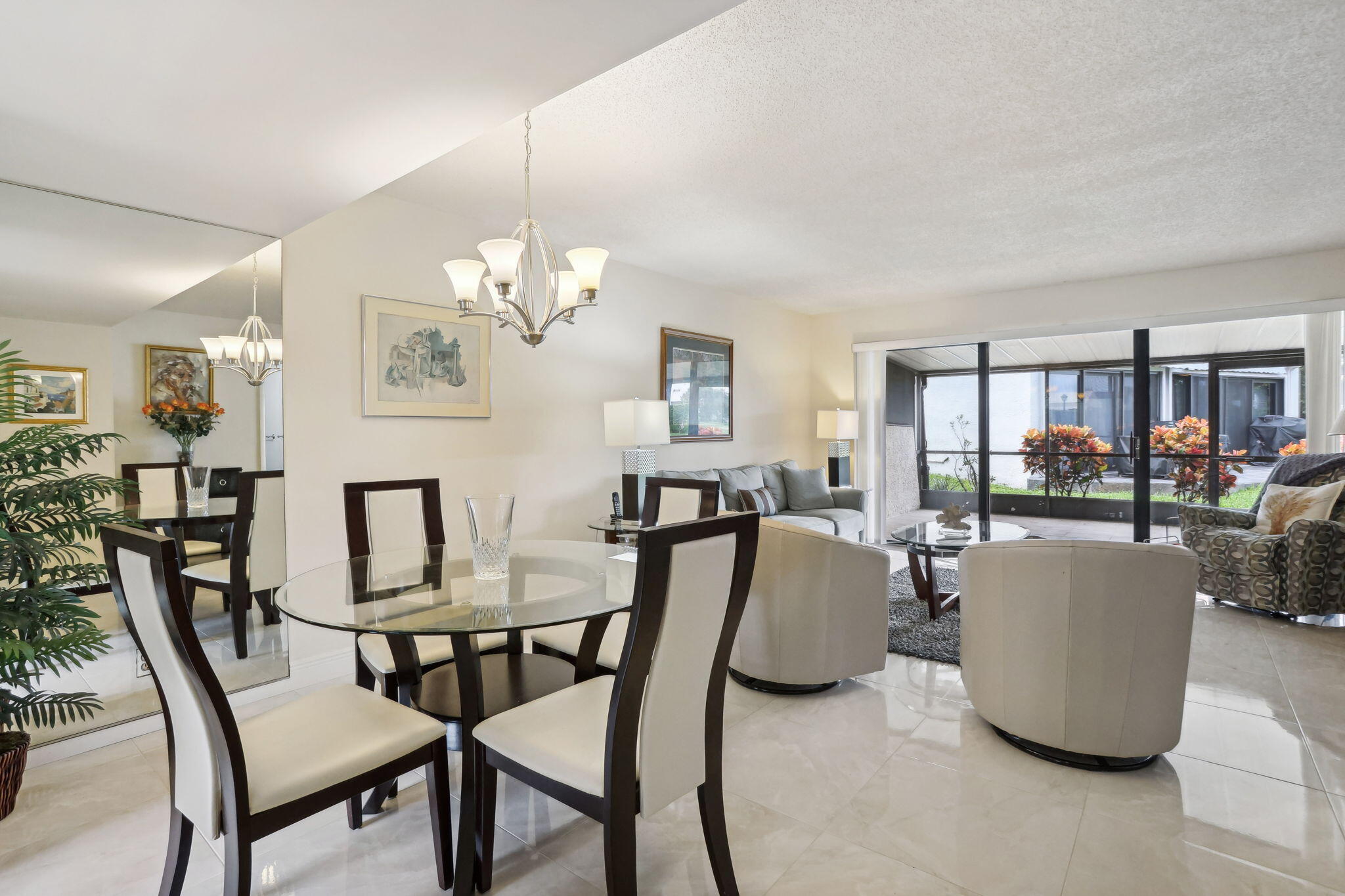 a view of a dining room with furniture and a chandelier