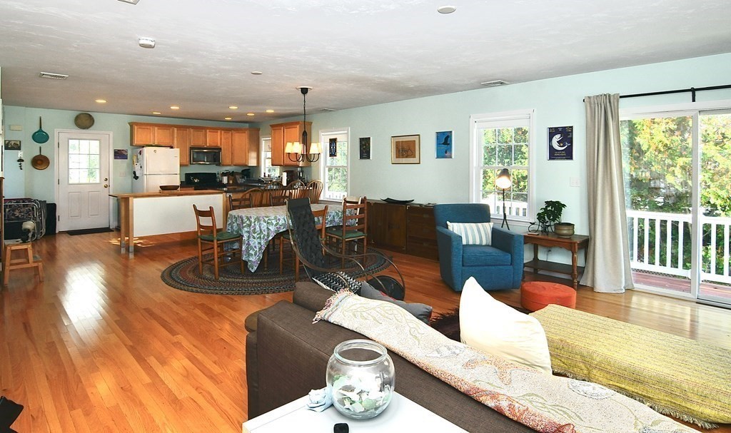 a living room with furniture wooden floor and a table