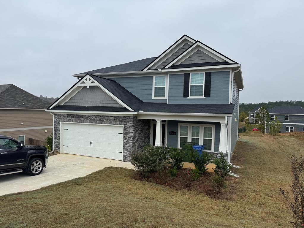 a front view of a house with a yard and garage