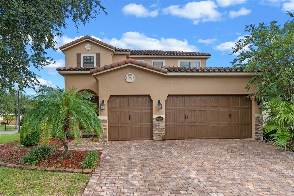 a view of a house with a yard and garage