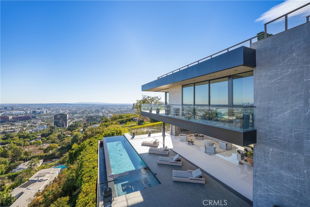 an aerial view of residential houses with outdoor space and swimming pool