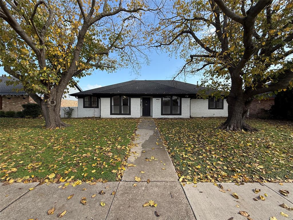 front view of a house with a tree