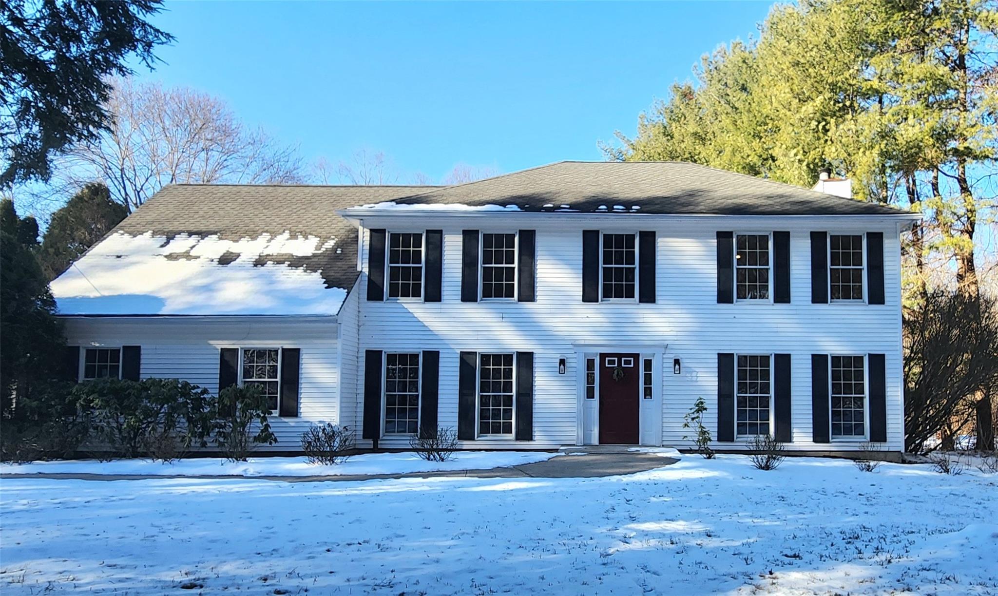 front view of a brick house with a yard