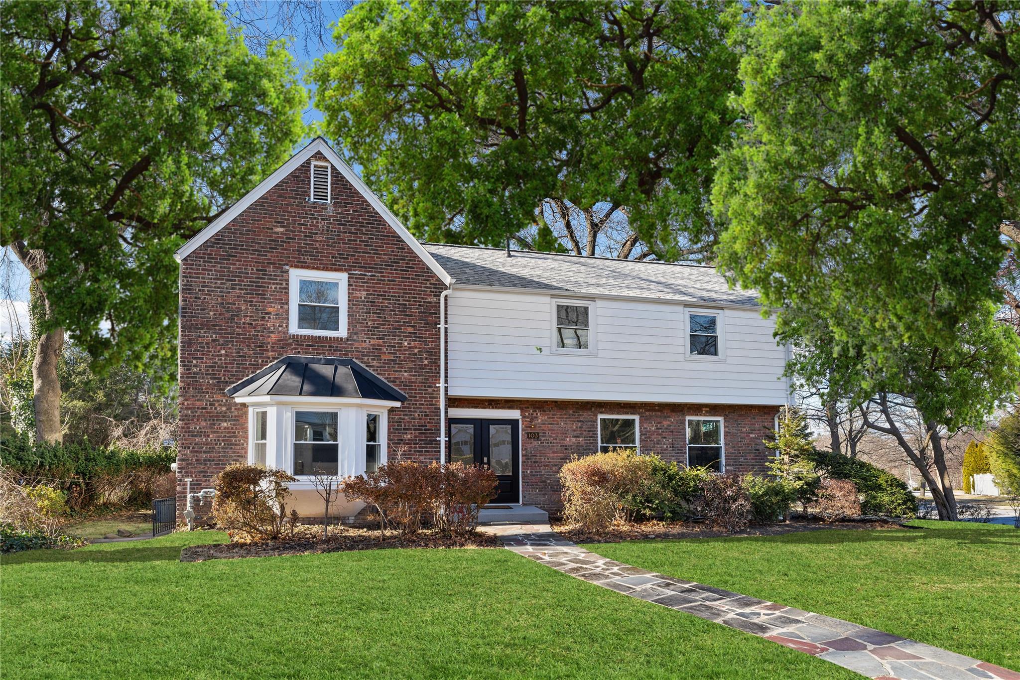 Welcome to 103 Grandview Boulevard located in Colonial Heights in Yonkers, NY! This photo has been virtually staged by adding a green lawn and leaves on the trees.