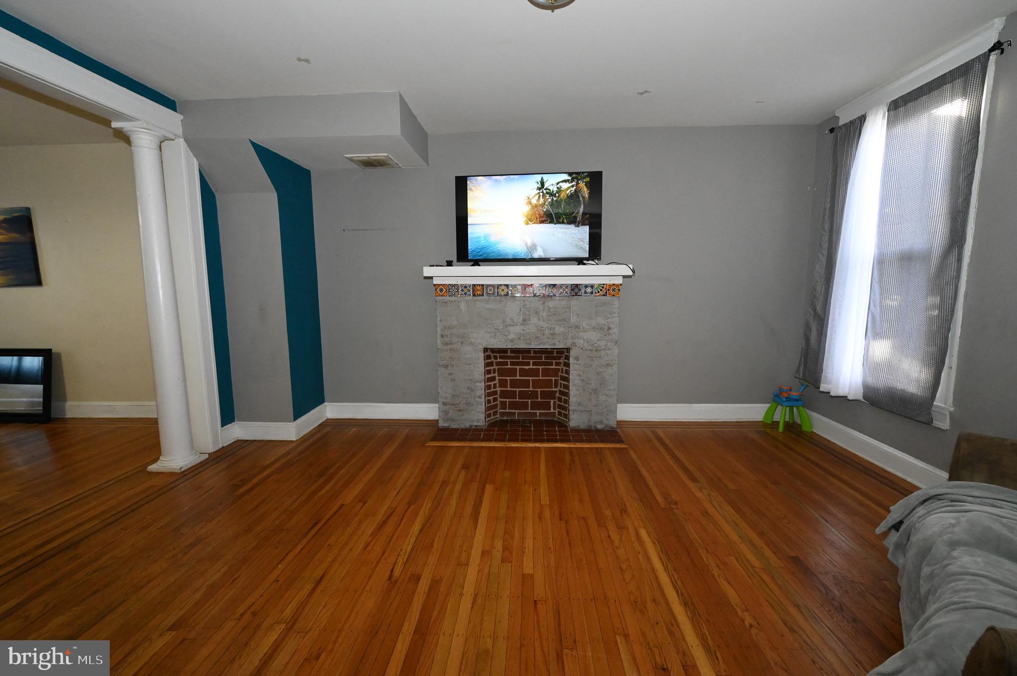 a view of livingroom with hardwood floor and a fireplace