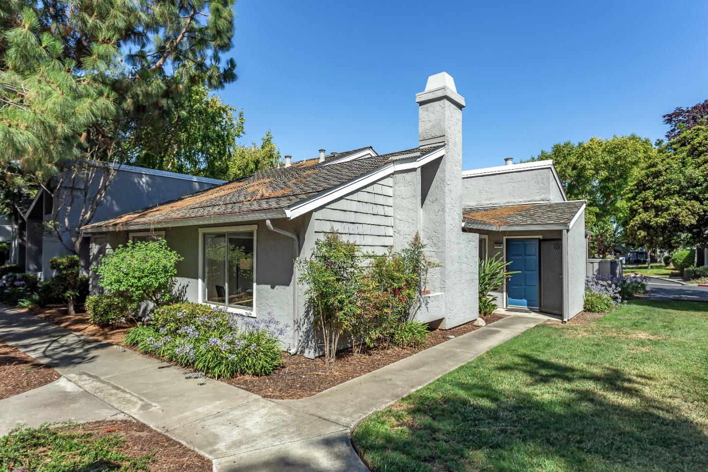 a front view of a house with garden