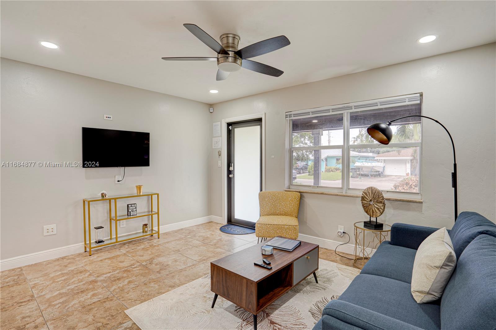 a living room with furniture and a flat screen tv