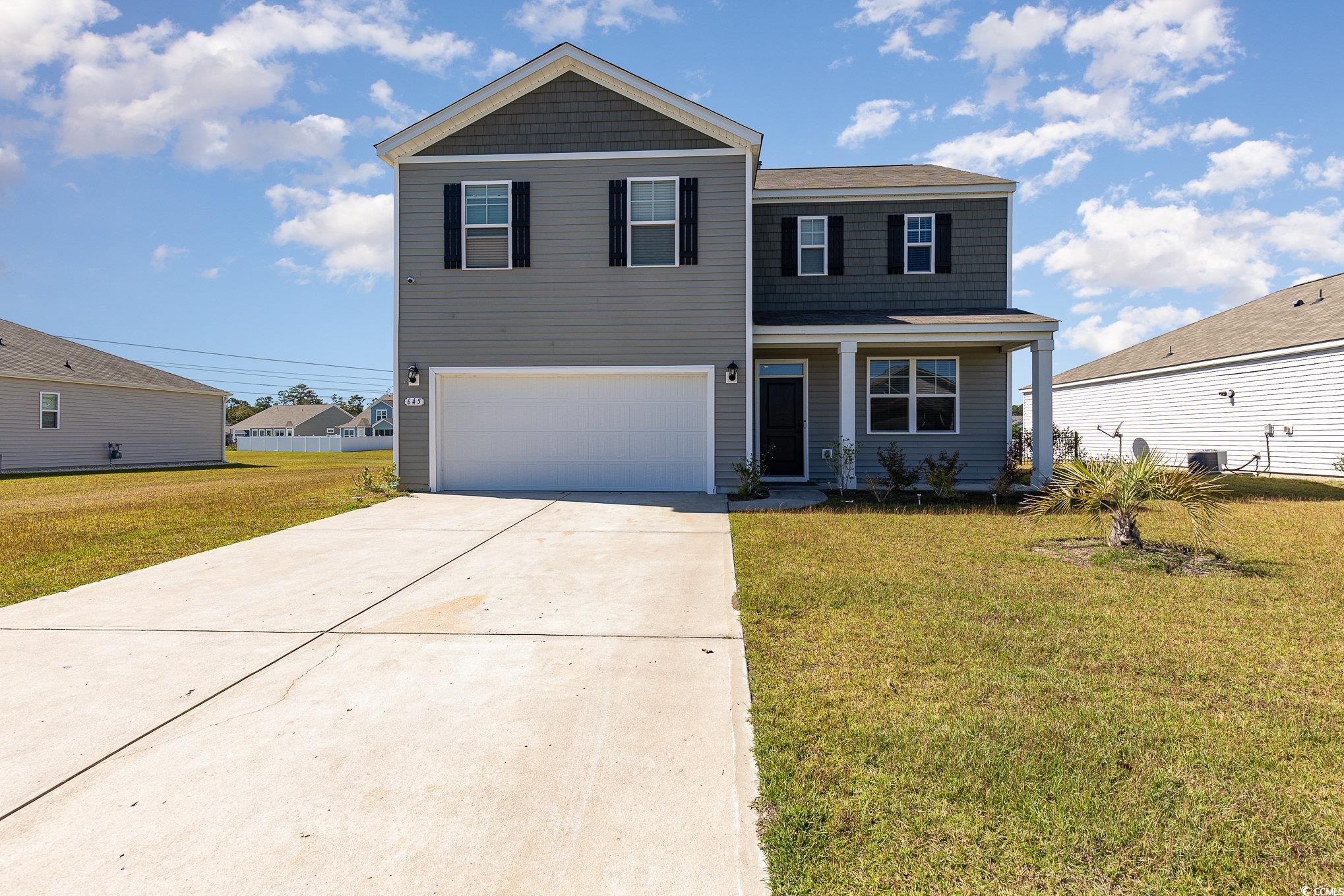 View of front of property with a front yard and a