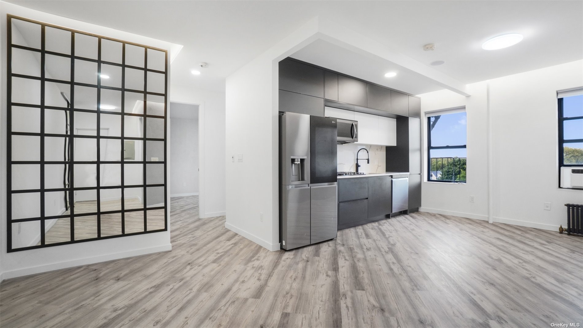 a kitchen with stainless steel appliances a refrigerator and wooden floor