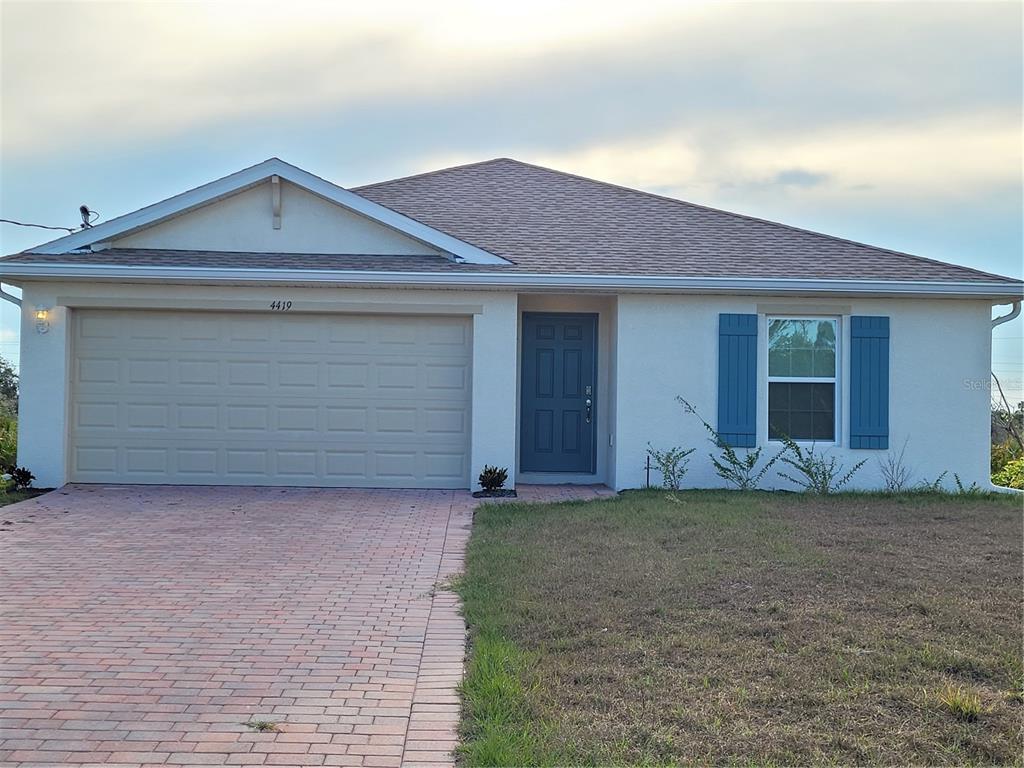 a front view of a house with a yard and garage