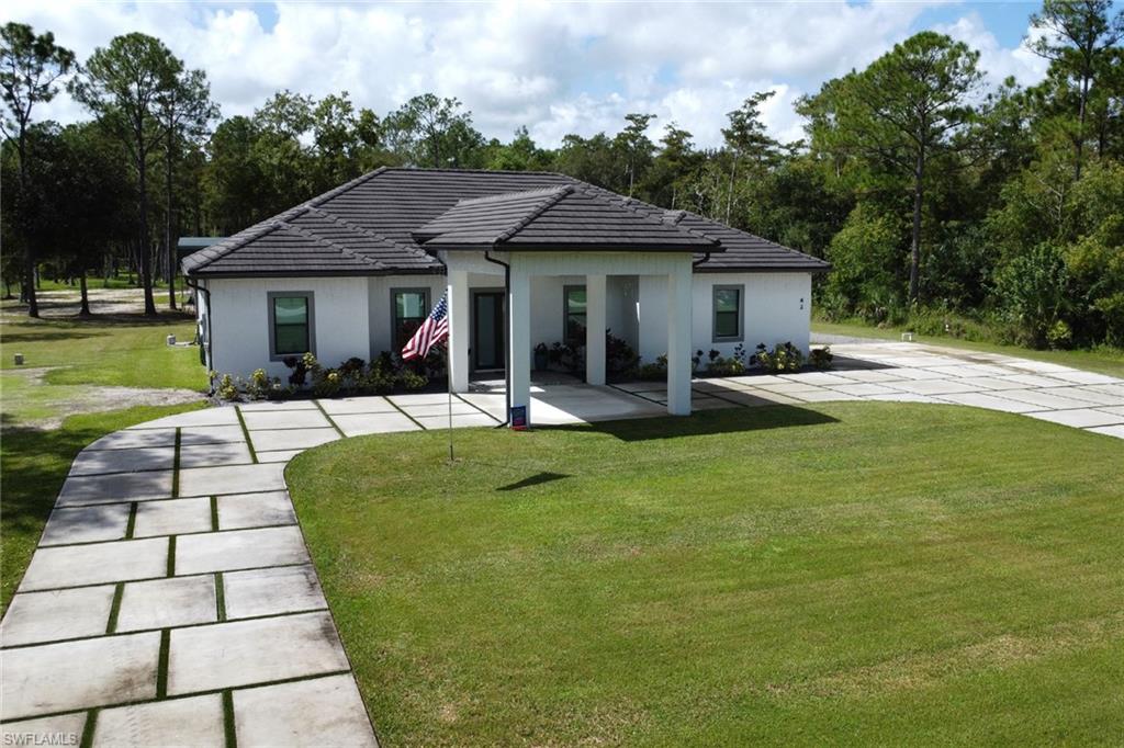 Rear view of house featuring a lawn