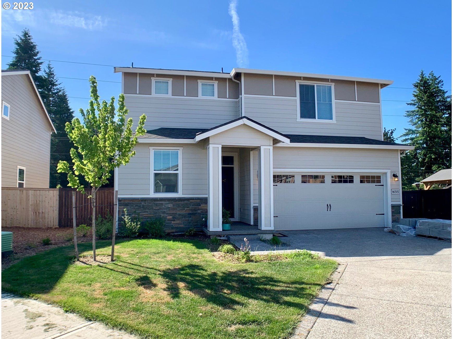 a front view of a house with a yard and garage