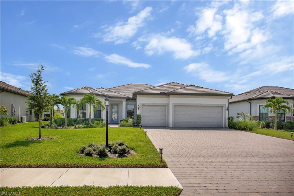 a front view of a house with a yard and garage