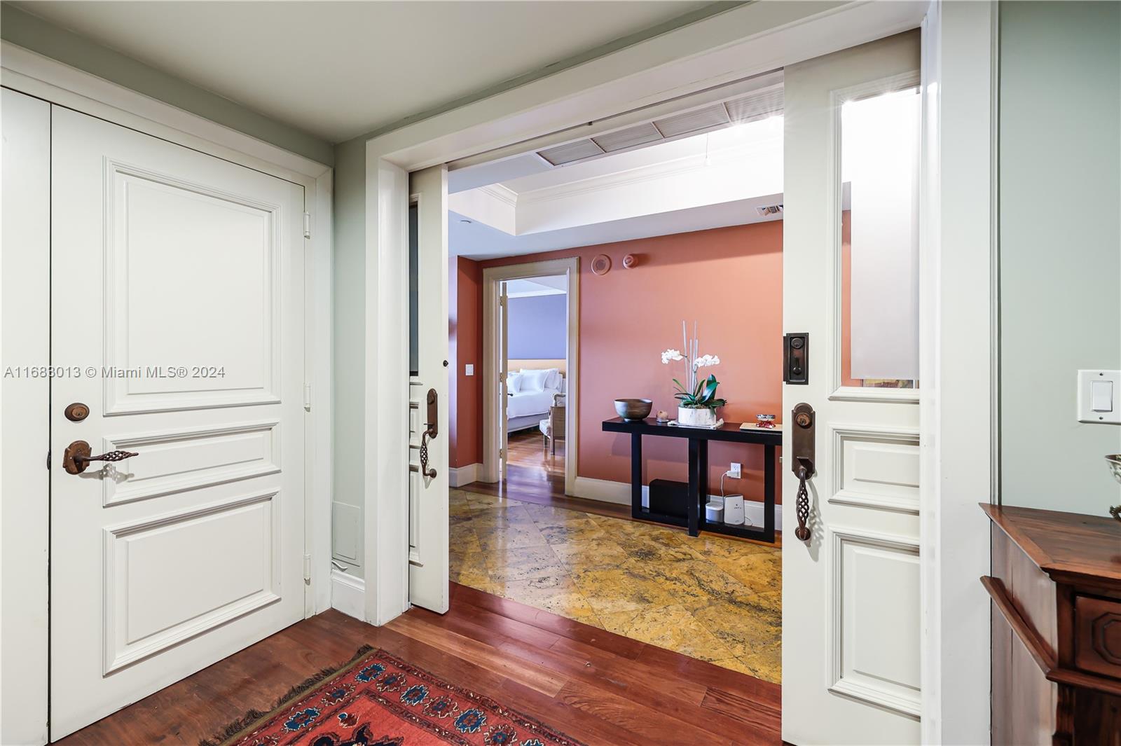 a view of a bedroom with wooden floor and furniture