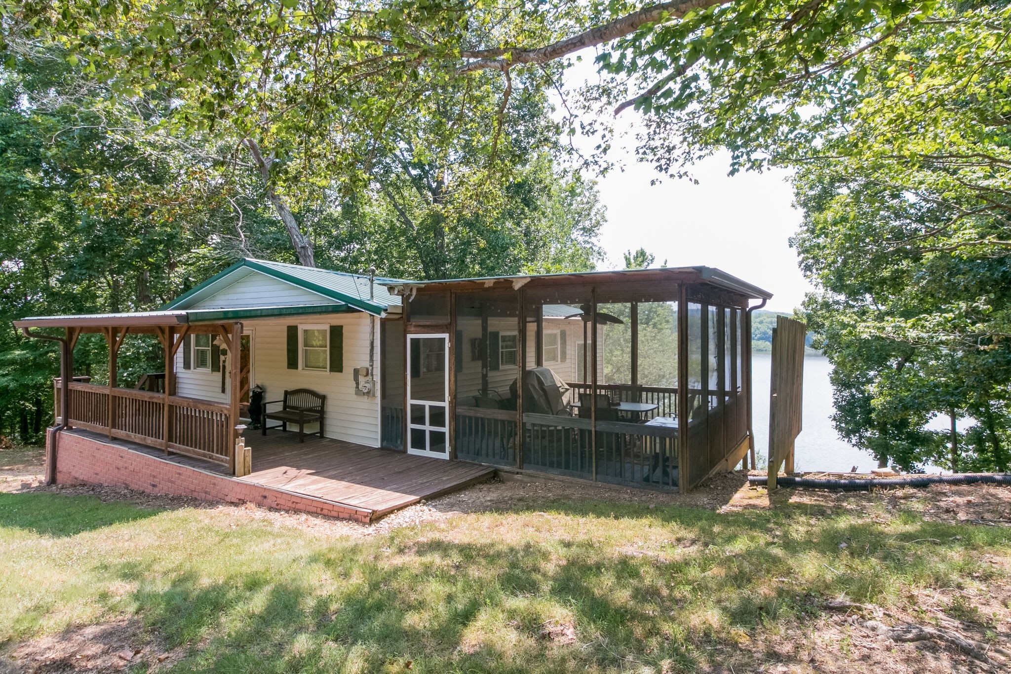 a backyard of a house with barbeque oven table and chairs