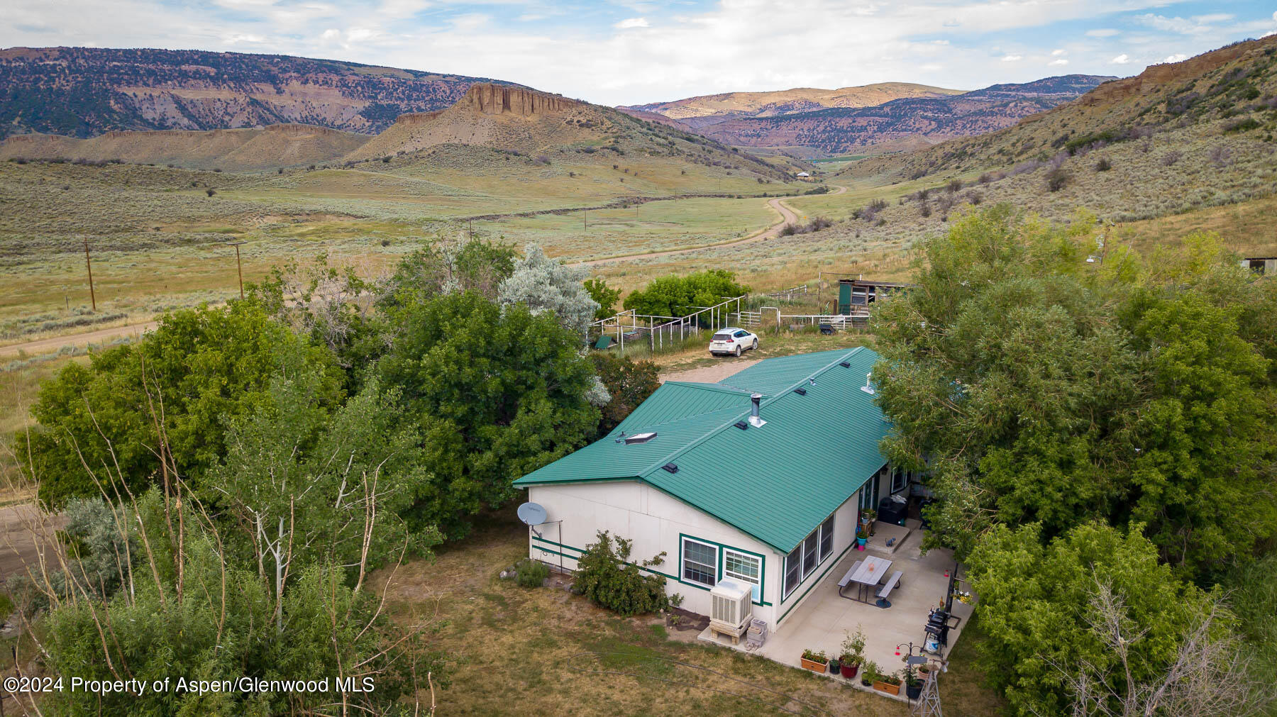 an aerial view of a house with a yard