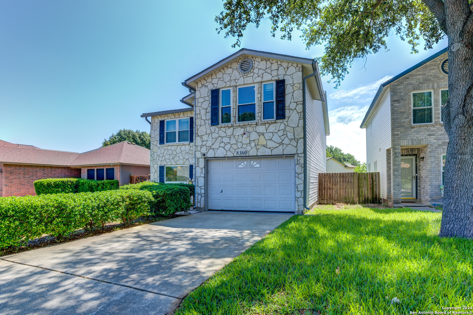 a front view of a house with a yard and pathway