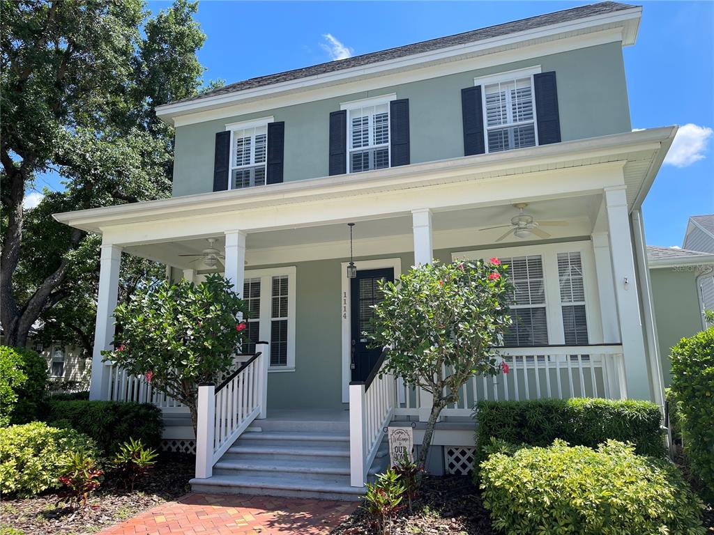 a front view of a house with plants