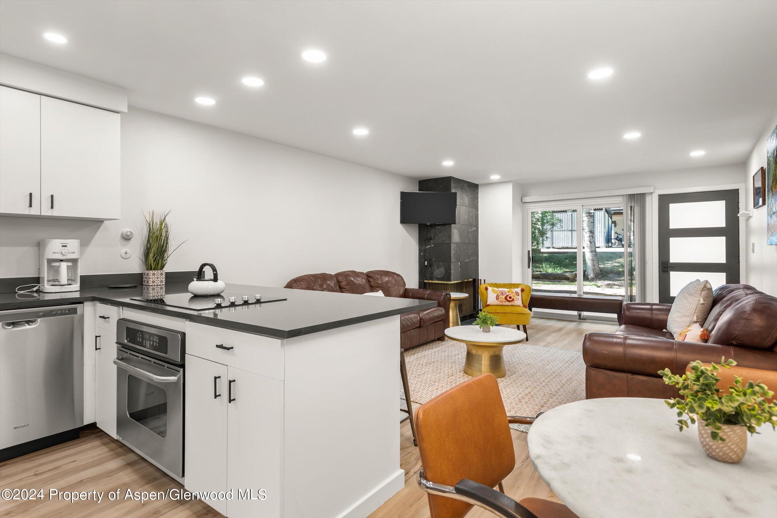 a kitchen with stainless steel appliances kitchen island granite countertop a sink and cabinets