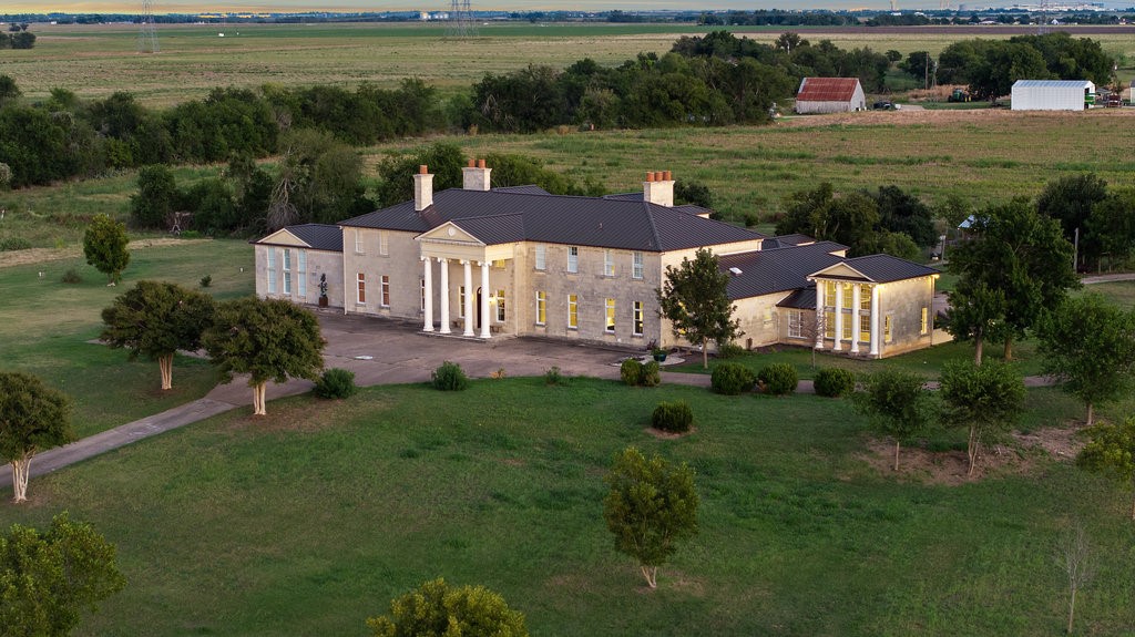 an aerial view of a house with garden space and street view