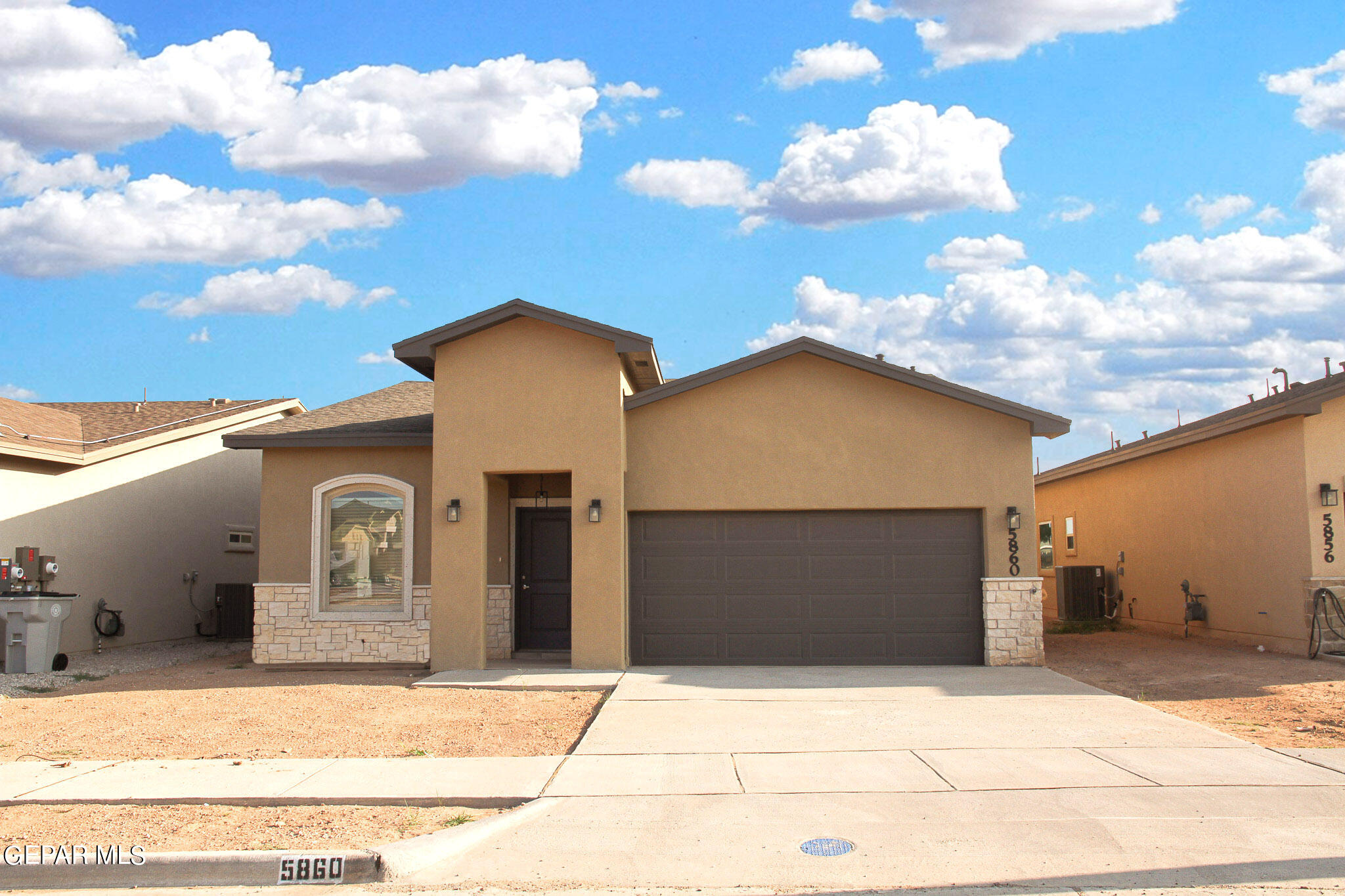 a front view of a house with a garage