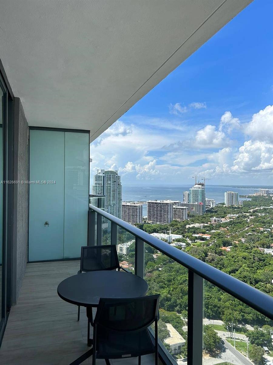 a view of a balcony with chairs