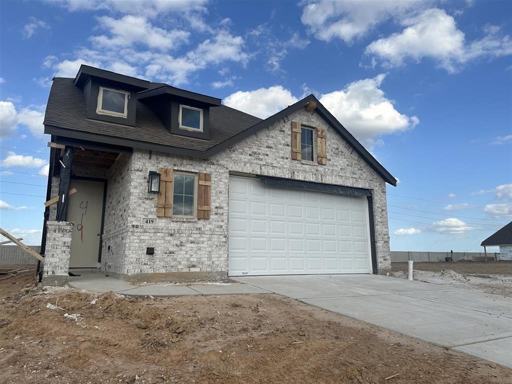 a front view of a house with a garage