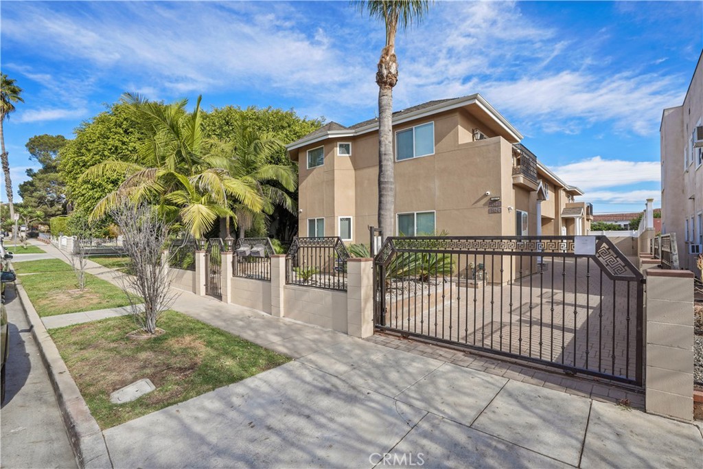 a view of a house with wooden fence