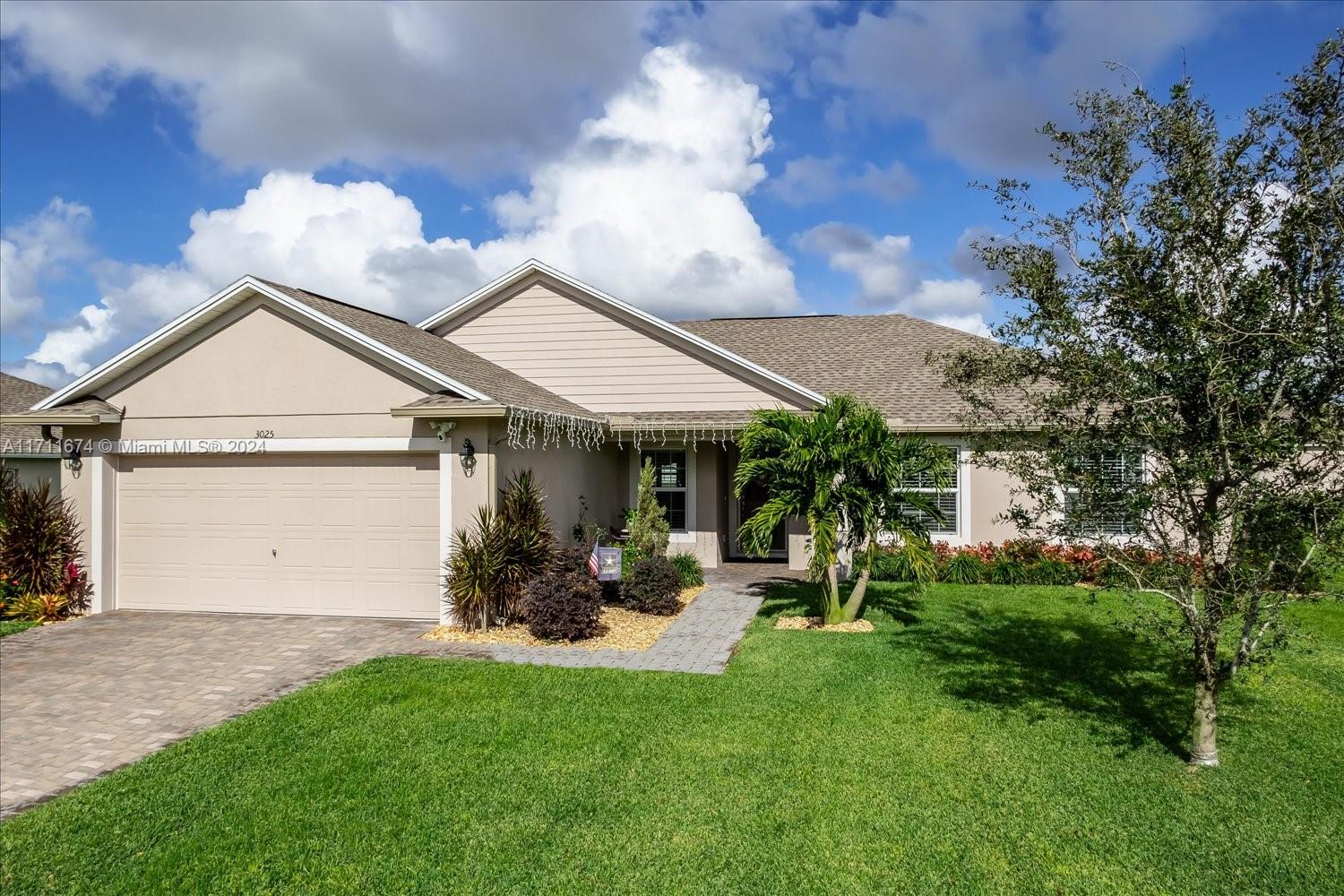 a front view of a house with a yard and a garage