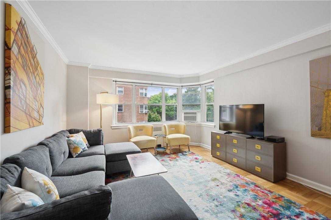 Living room featuring hardwood floors, large bay windows