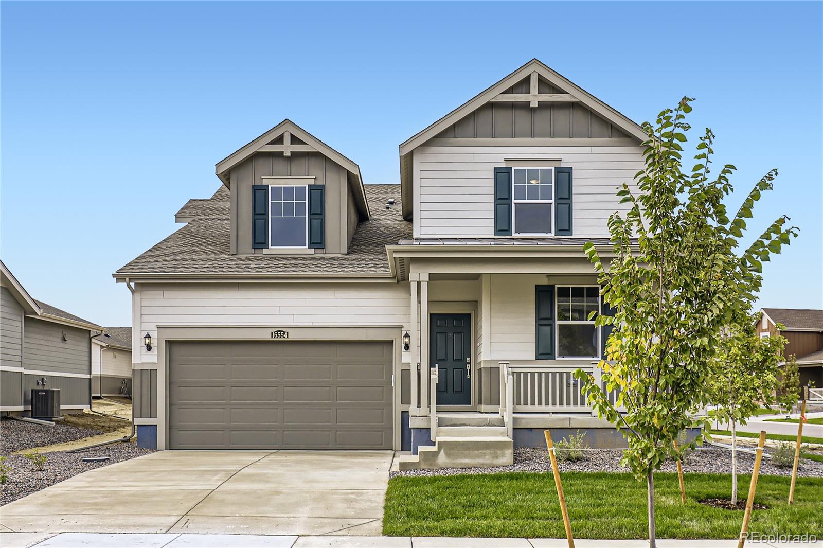 a view of a house with a yard and garage