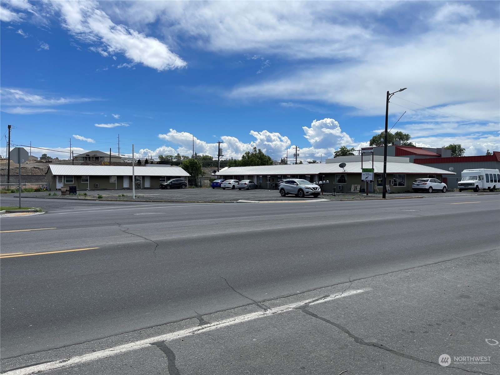 a view of a building with car parked