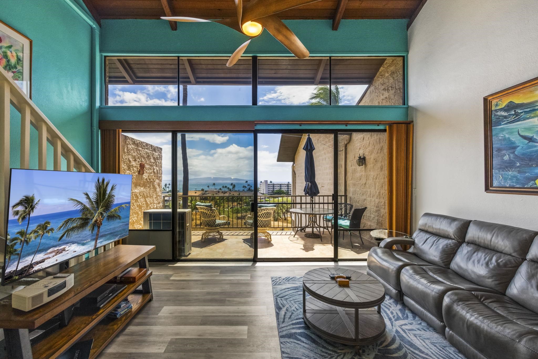 a living room with patio furniture and a floor to ceiling window