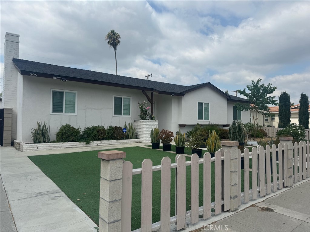 a front view of house with yard having green space