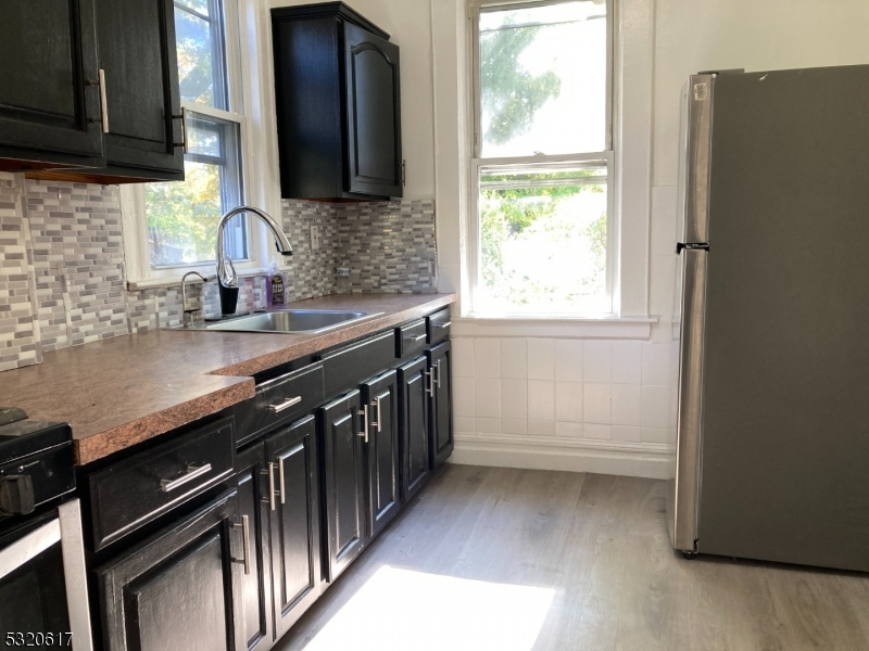 a kitchen with a sink a window and appliances