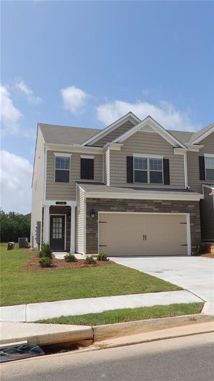 a front view of a house with a yard