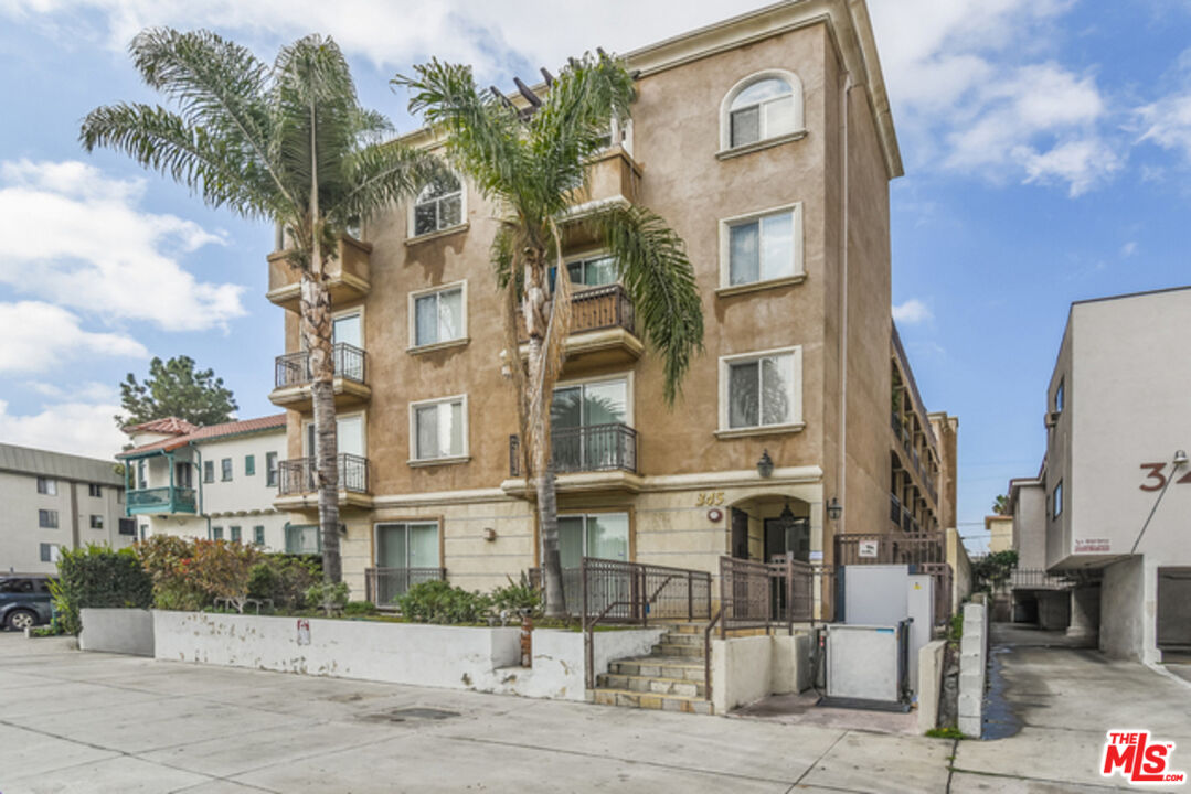 a front view of a residential apartment building with a yard