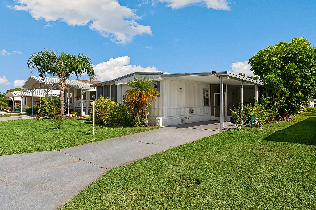 a view of a house with yard and a garden