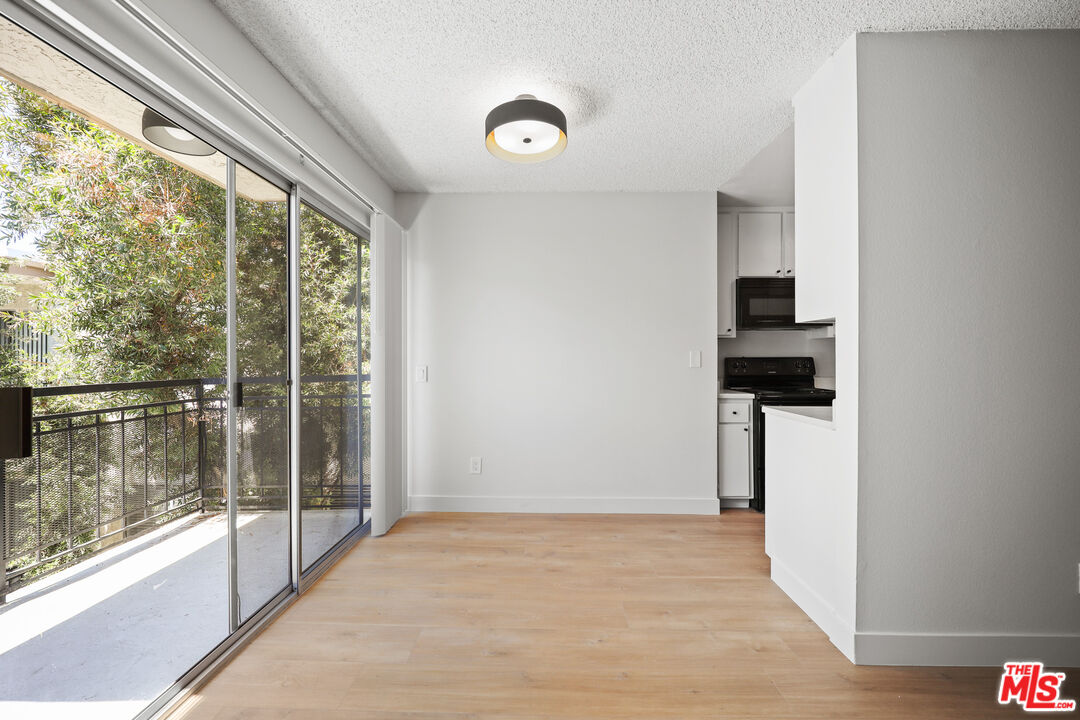 a view of empty room with floor to ceiling window