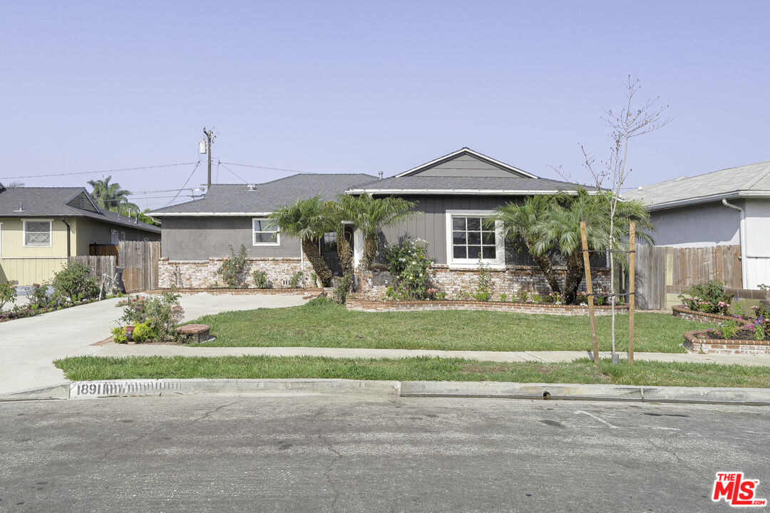 a front view of a house with a yard and a garage