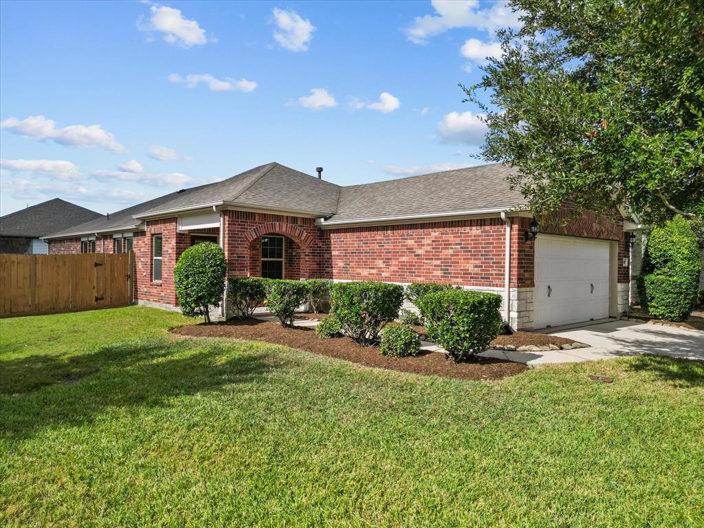 a front view of a house with a garden and yard