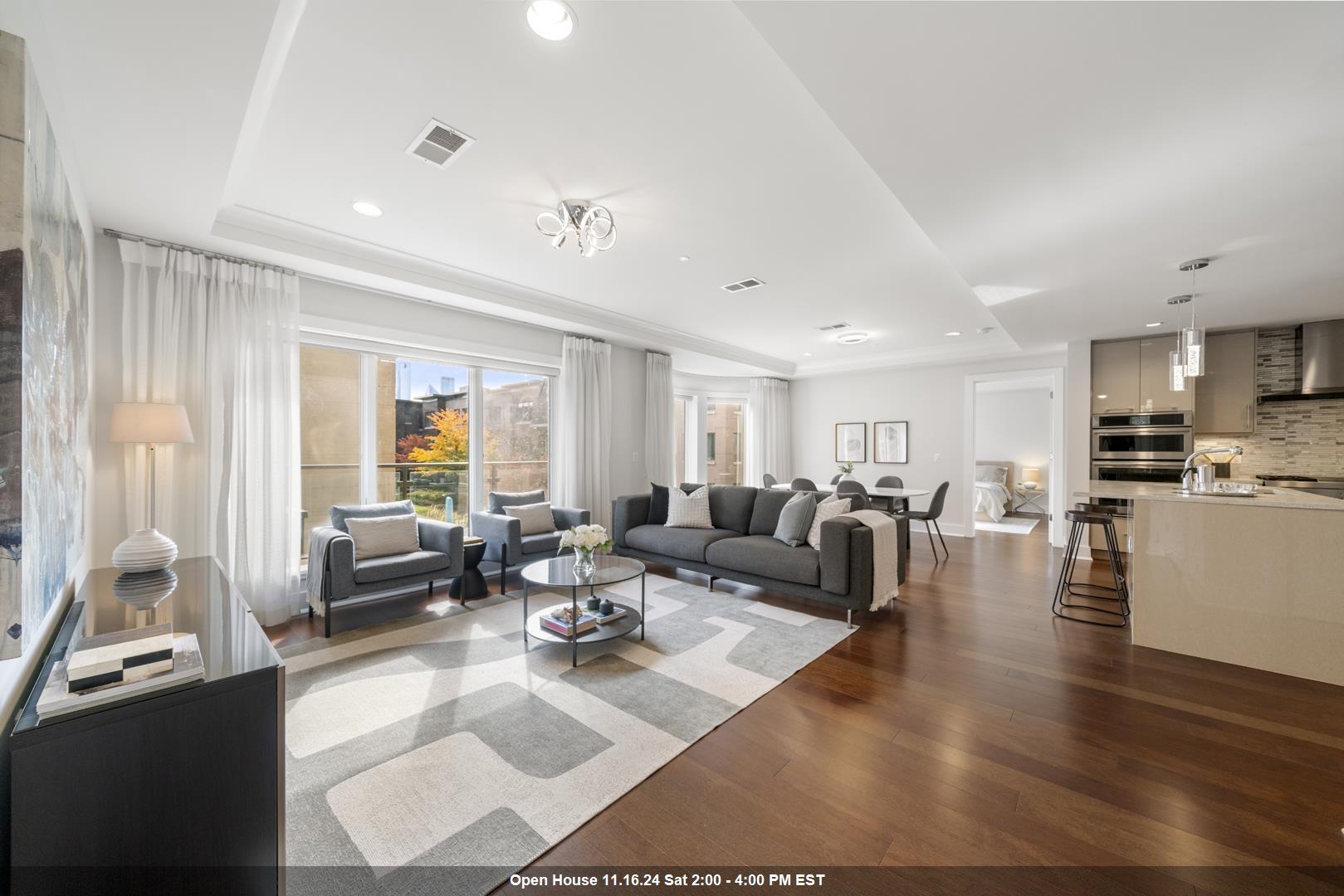 a living room with lots of furniture and a large window